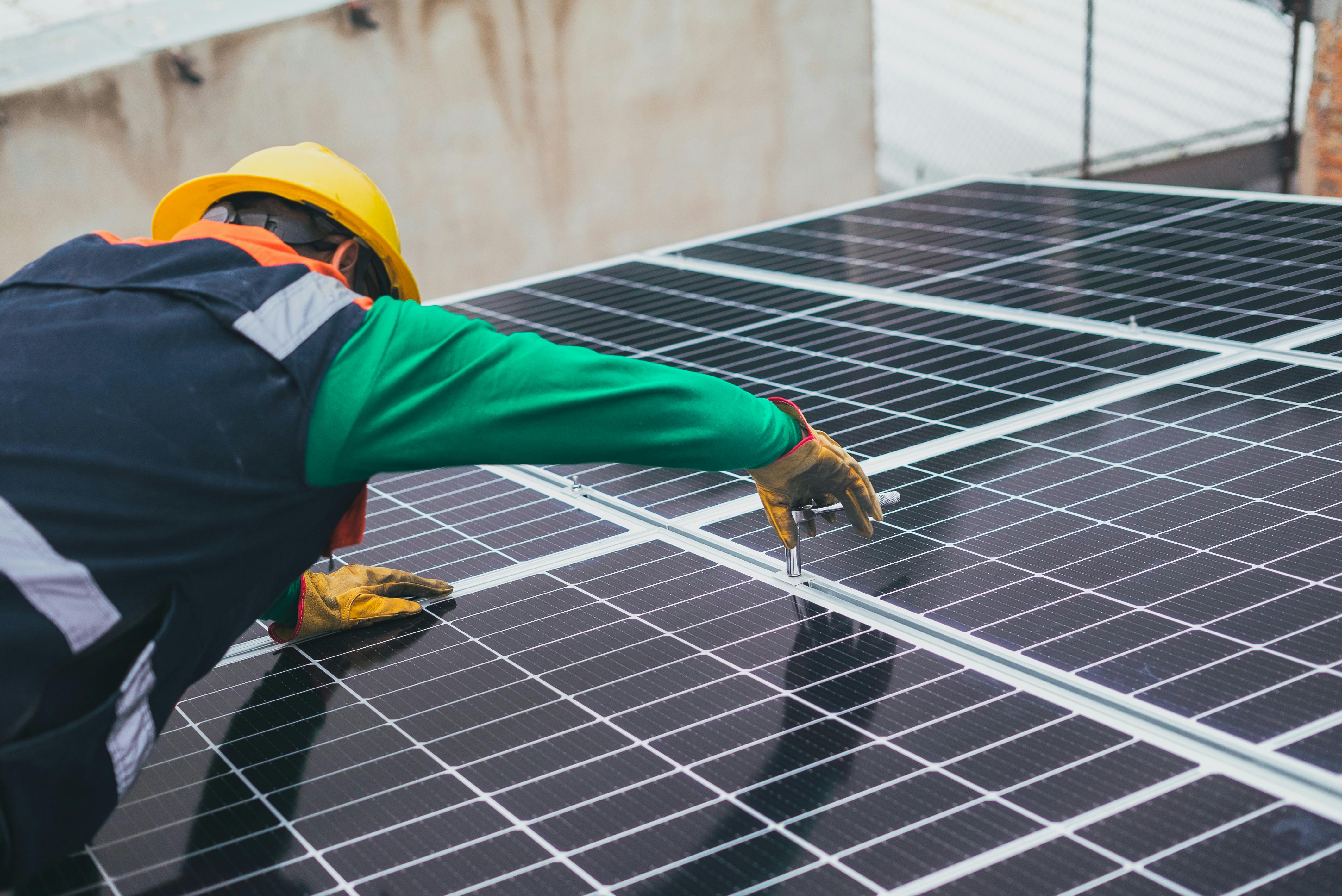 a solar technician working on a panel